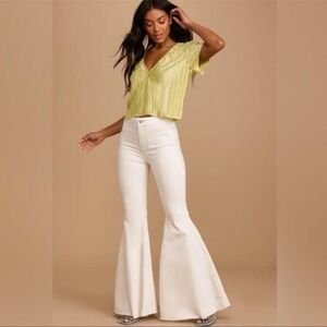 Free People "Just Float On" flare jeans in a white denim wash.